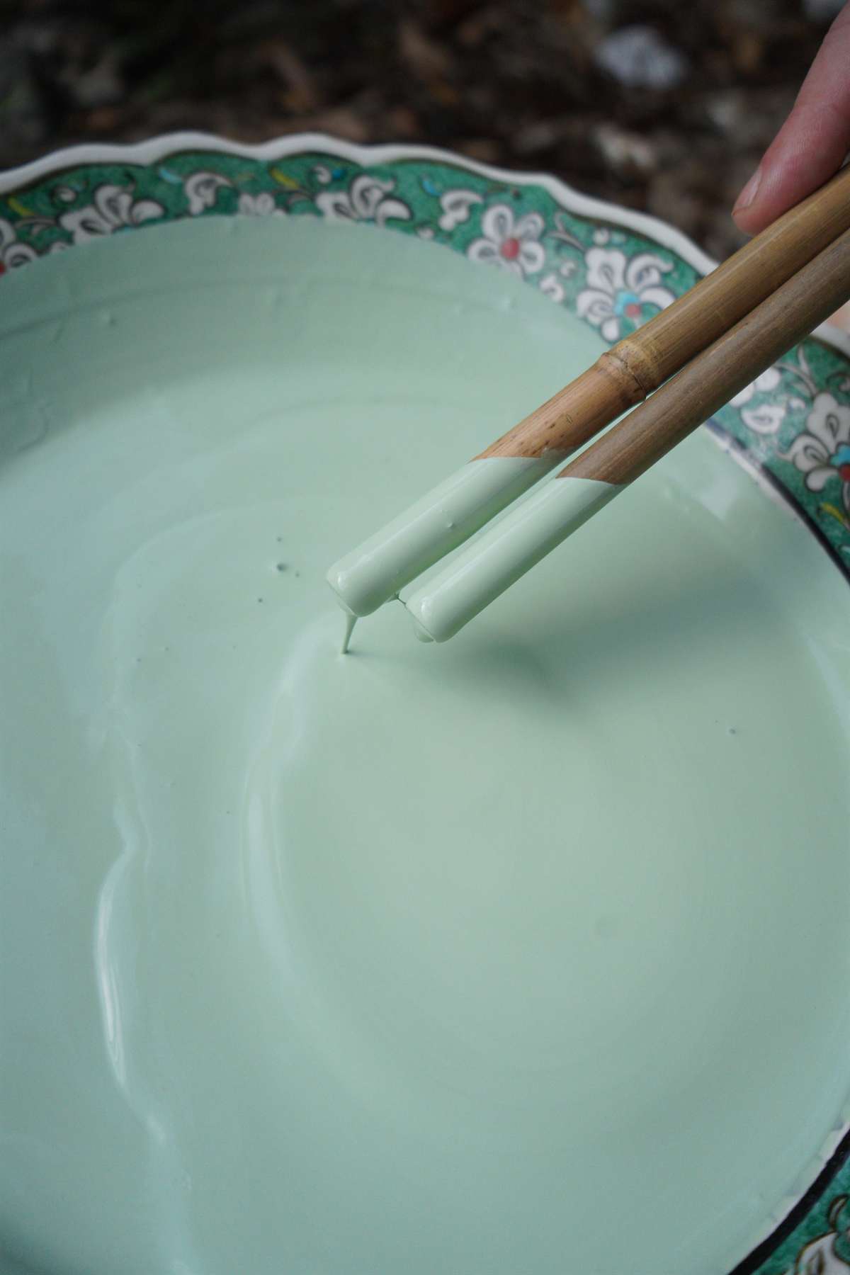 Verdigris ceramic glaze being prepared by hand in the atelier.