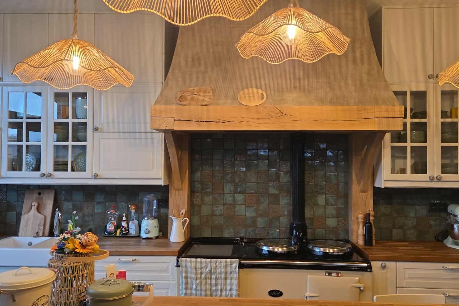 Green handmade ceramic tiles installed in a warm kitchen interior.